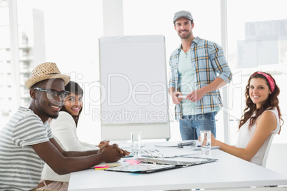 Businessman presenting and smiling colleagues listening Businessman presenting and smiling colleagues listening