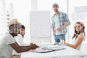 Businessman presenting and smiling colleagues listening