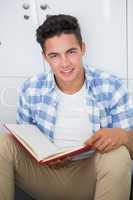 Smiling college student holding notebook