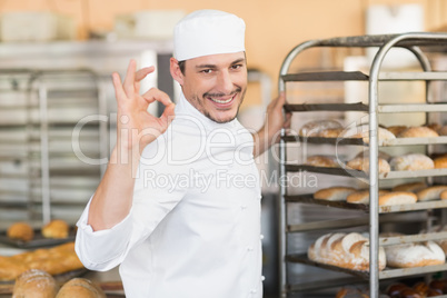 Smiling baker making ok sign with hand