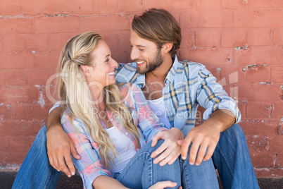 Attractive couple sitting on ground