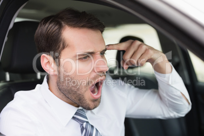 Businessman experiencing road rage