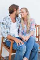 Attractive couple sitting on bench