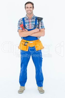 Confident plumber holding monkey wrench and plunger