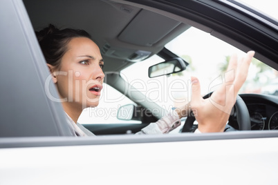Pretty businesswoman experiencing road rage