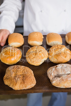 Close up of baker showing tray with bread