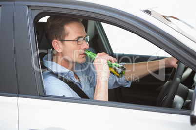 Man drinking beer while driving