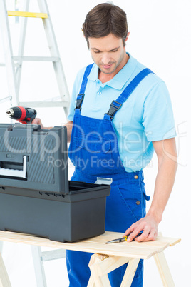 Carpenter removing tools from box