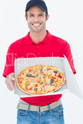 Happy delivery man showing fresh pizza