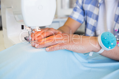 College student using sewing machine