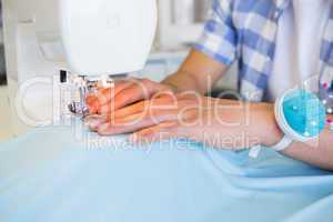 College student using sewing machine