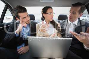 Business team working in the back seat