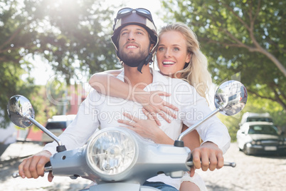 Attractive couple with their scooter