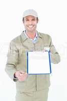 Happy delivery man giving clipboard and pen for signature