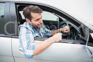 Young man smiling and driving