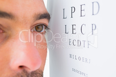 Focused man on eye test letters