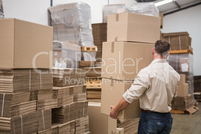 Rear view of worker carrying boxes