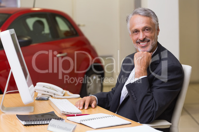 Cheerful businessman working at his desk