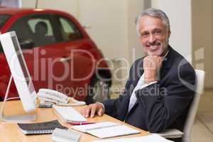 Cheerful businessman working at his desk