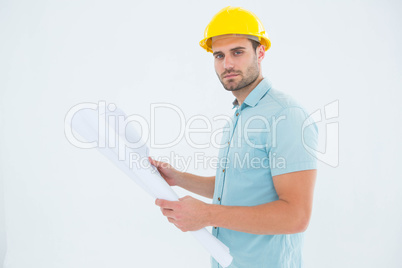 Confident male architect holding blueprint