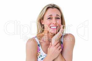 Blonde woman suffering with teeth pain