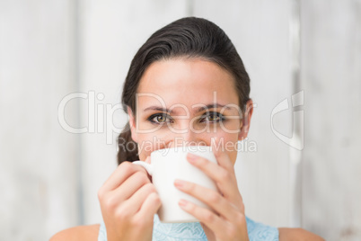 Stylish brunette holding a mug