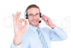 Smiling businessman with headset making ok sign