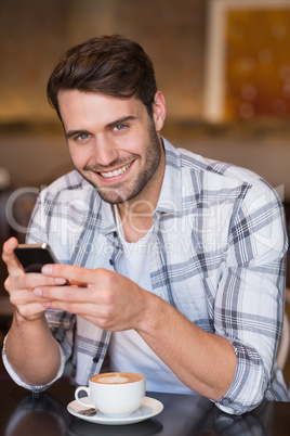 Young man sending a text