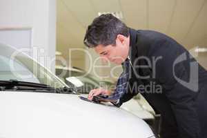 Focused cleaning a stain with his tie