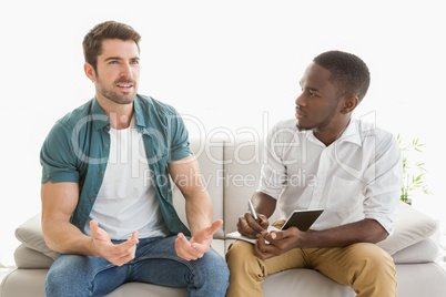 Therapist taking notes on his depressed patient