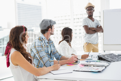 Serious colleagues listening businessman attentively