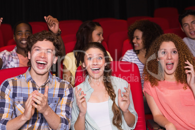 Young friends watching a film