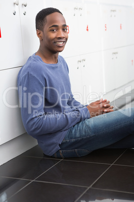 Portrait of university student sitting on the floor