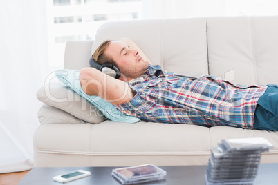 Man napping on sofa with music