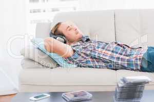 Man napping on sofa with music