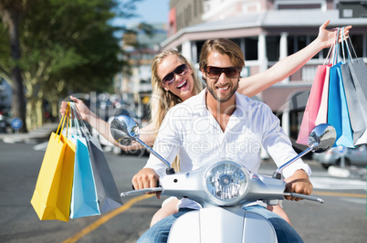 Attractive couple riding a scooter