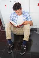 Concentrated college student reading notebook