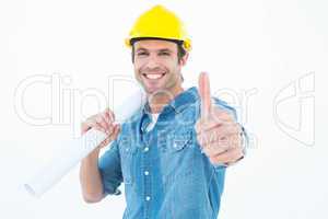 Architect holding blueprint while gesturing thumbs up
