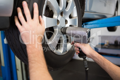 Mechanic adjusting the tire wheel