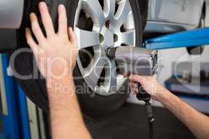 Mechanic adjusting the tire wheel