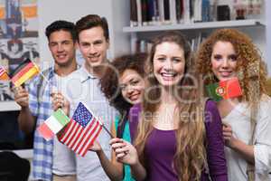 Happy students waving international flags