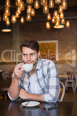 Young man having cup of coffee