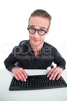 Businessman making a face working at desk