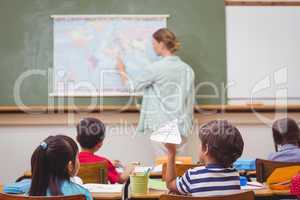 Naughty pupil about to throw paper airplane in class