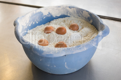 Eggs in bowl of flour