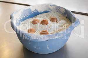 Eggs in bowl of flour