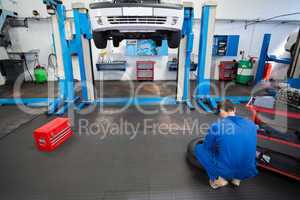 Mechanic working on a tire wheel