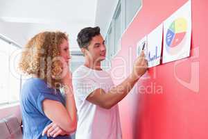 Students studying together with graphics on the wall