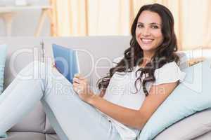 Pretty brunette using tablet pc on couch