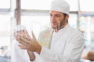 Baker clapping flour from his hands